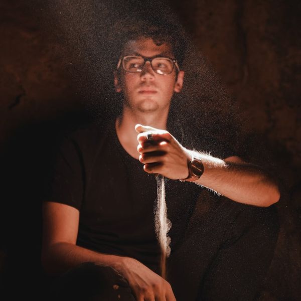 Man in a meditative pose after a workout, looking serene and focused.